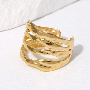 Detailed macro view of 18K gold plated multi-layer ring with irregular hammered texture