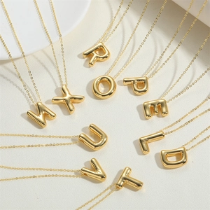 Balloon style 14K gold plated initial pendant necklaces with mirror finish on white background
