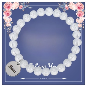Détail d'un bracelet en perles avec pendentif cœur gravé Mom sur carte cadeau