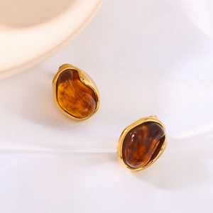 Asymmetric amber resin stud earrings with 18K gold plated stainless steel on silk