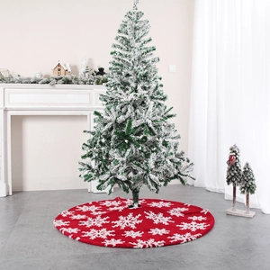Red plush Christmas tree skirt with white snowflake patterns in a cozy home setting