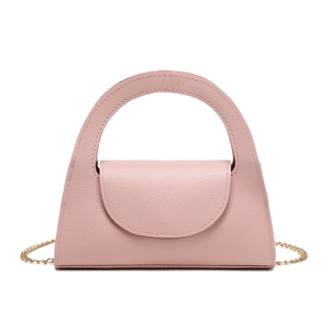 Pink leather handbag with curved handle and gold chain strap on white background