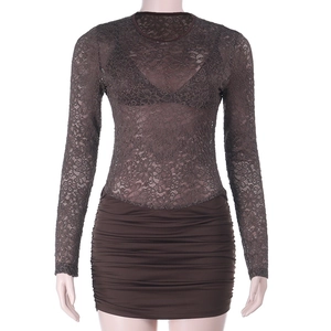 Close-up of dark brown lace long sleeves and ruched mini skirt detail on a slim dress