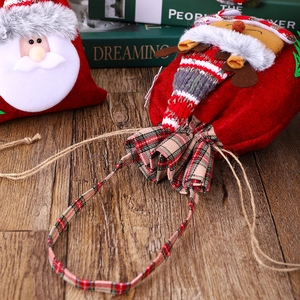 Detail of Christmas gift bags featuring Santa and reindeer motifs in red felt and knit