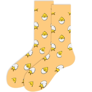 Detailed view of yellow crew socks featuring cute cartoon chicken hatching patterns