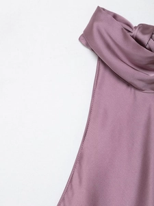 Detail of mauve satin backless top showing glossy fabric and knotted neckline design