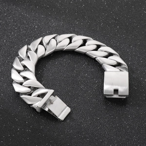 Close-up of brushed silver stainless steel Cuban link bracelet with square clasp