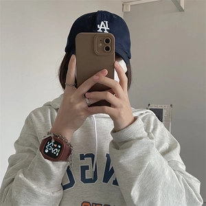 Wrist shot of a stylish brown square digital watch worn with a casual daily outfit