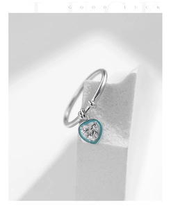 Detail of S925 sterling silver ring featuring a blue heart pendant and clear gemstone