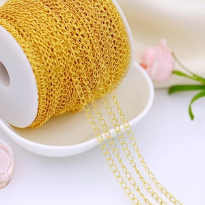 Detail of 18K gold-plated copper chain on a white spool for DIY jewelry making