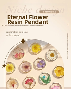 Detail of round copper frames with real dried flowers embedded in clear resin pendants