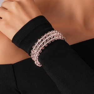 Detailed view of triple-layered pink beaded bracelet with sparkling crystal spacers
