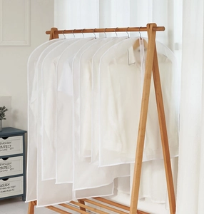 Translucent PEVA garment bags hanging on a rack for dustproof clothing storage