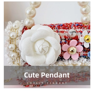 Detail of tweed girls handbag with white camellia flower and pearl handle details