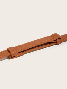Close-up of brown leather waist belt featuring a detailed cross-grain texture and stitching