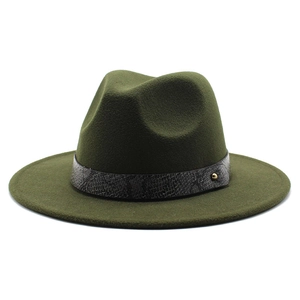 Macro detail of dark green fedora with snakeskin leather band and gold stud accent