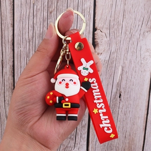 Close-up of 3D Santa Claus keychain with red PVC wrist strap and golden metal clasp