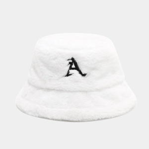 Macro view of plush white faux fur bucket hat with black letter A embroidery texture