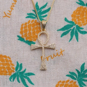 Golden Ankh cross pendant necklace with clear zircon pavé stones on a box chain