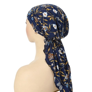 Detail of floral printed headscarf with two long tail ties on a mannequin head