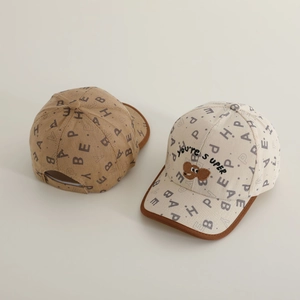 Two kids' vintage corduroy baseball caps with letter prints and bear embroidery details