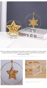 Golden metal Christmas star and snowflake ornaments with transparent crystal base detail