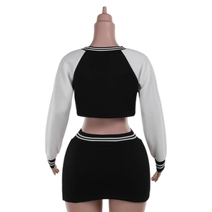 Rear view of black and white baseball-style two-piece set with long sleeves and mini skirt