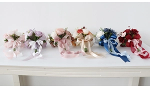Detail showing artificial wedding bouquets with long matching ribbons in six assorted colors