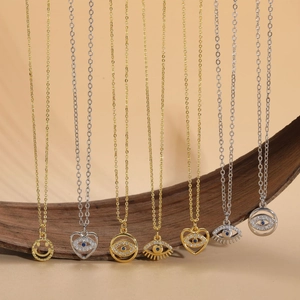 Evil Eye and heart pendants in gold and silver finish with blue zircon gemstones