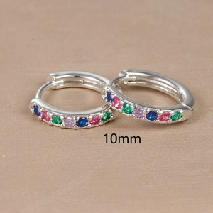 Detail view of 10mm silver huggie earrings with rainbow multi-color inlaid stones