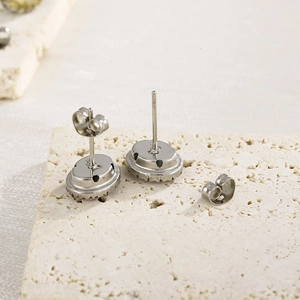 Macro detail of the silver earring back construction including secure metal butterfly backs