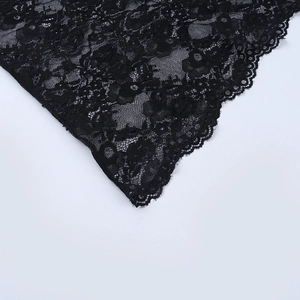 Close-up of black lace fabric showing intricate floral crochet patterns and scalloped edges