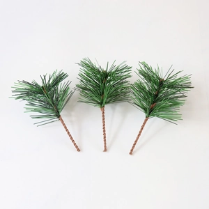Macro shot of three artificial dark green pine needles with brown twisted wire bases