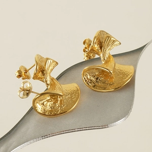 Sparkling gold bow-shaped stud earrings with unique hammered texture for a modern look
