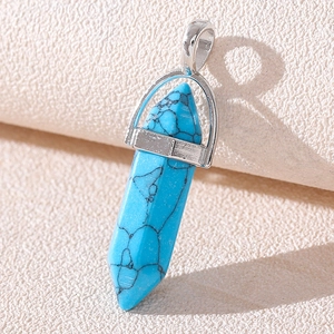 Detailed macro view of a hexagonal turquoise stone pendant with silver metal bail