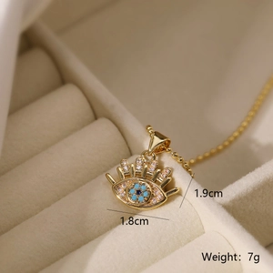 Macro shot of gold-plated evil eye pendant with blue zircon stones and dimension labels