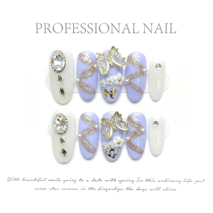 Macro detail of handmade press-on nails with 3D metal butterflies and purple crystals