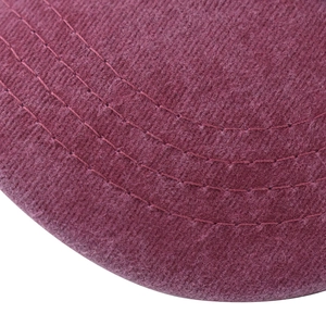 Detailed macro view of triple stitching on burgundy washed cotton baseball cap brim