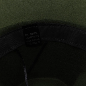 Detail shot of the interior sweatband and material label of this wool felt fedora hat