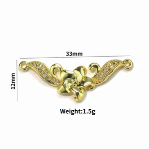 Detail view of 18k gold plated leaf pendant with zircons, size 33mm by 12mm