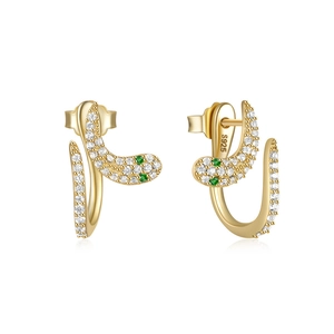 Detail of 925 silver snake earrings with gold plating, white zircons and green eyes