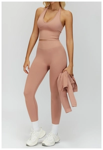 Close-up of pink high-waisted seamless yoga set with ribbed waistband and compression fabric