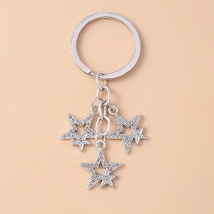 Detail of silver star keychain with sparkling rhinestones and metal hollow-out design