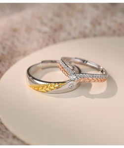 Macro detail of wheat ear couple rings in S925 silver with sparkling zircon stones