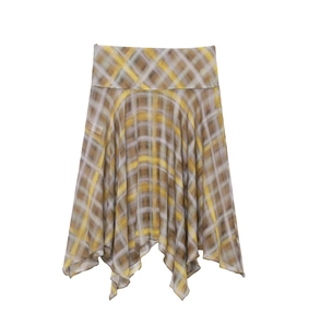 Detail of asymmetric handkerchief hem on a high-waisted yellow and grey plaid midi skirt