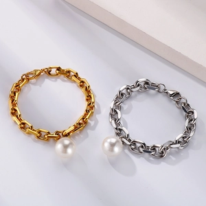 Detailed view of titanium steel chain bracelet with large pearl charm in gold and silver