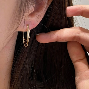 Elegant gold multi-layer tassel chain earrings shown on a model for a chic metal look