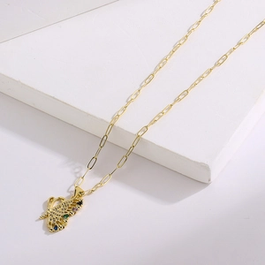 Macro detail of a 18K gold plated butterfly pendant with colorful zircon stones on a white stand