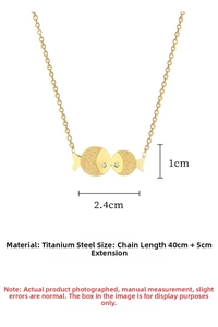 Macro detail of gold kissing fish pendant with mixed matte and polished finishes