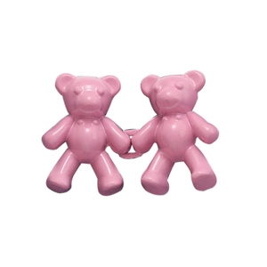 Close-up of pink bear waist buttons for jeans with a smooth resin finish